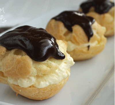 Cream Puffs, Dipped in Ganache and Filled with Whipped or Pastry Cream.